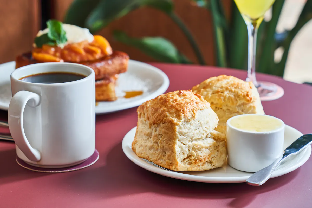 a close up of a plate of food and a cup of coffee